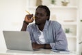 Thoughtful Young African American Man Holding Pencil And Looking At Laptop Screen Royalty Free Stock Photo