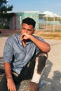 Thoughtful young African American man looking away while sitting in the park Royalty Free Stock Photo