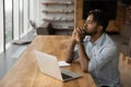 Pensive biracial man work on laptop thinking Royalty Free Stock Photo