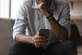 Thoughtful young african mixed race man using cellphone.