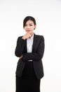 Thoughtful young asian businesswoman resting her chin on her hand and looking straight into the camera, half length portrait with Royalty Free Stock Photo