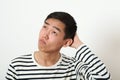 Thoughtful young Asian man looking upward Royalty Free Stock Photo