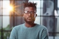 Thoughtful young black man in glasses looking straight ahead Royalty Free Stock Photo