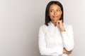 Thoughtful young black woman touch chin, businesswoman looking thinking of deal success smiling Royalty Free Stock Photo