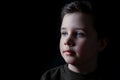 Thoughtful young boy in a lowkey portrait Royalty Free Stock Photo