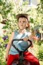 Thoughtful young boy sitting in a country garden Royalty Free Stock Photo