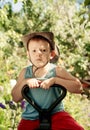 Thoughtful young boy sitting in a country garden Royalty Free Stock Photo