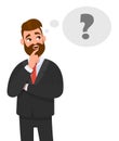 Thoughtful young business man thinking. Question mark icon in thought bubble. Royalty Free Stock Photo