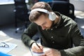 Thoughtful young business man writing something down while working in modern office Royalty Free Stock Photo