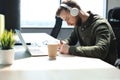 Thoughtful young business man writing something down while working in modern office Royalty Free Stock Photo