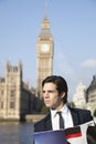 Thoughtful young businessman with book against Big Ben clock tower, London, UK Royalty Free Stock Photo