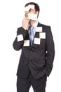 Thoughtful young businessman with post-it notes on his face and Royalty Free Stock Photo