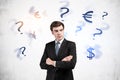 Young businessman and currency choice Royalty Free Stock Photo