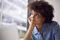 Thoughtful Young Businesswoman In Modern Office Working On Laptop Using Wireless Headset Royalty Free Stock Photo