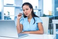 Thoughtful young businesswoman sitting at her desk Royalty Free Stock Photo