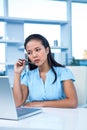 Thoughtful young businesswoman sitting at her desk Royalty Free Stock Photo