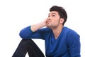 Thoughtful young casual man sitting and looking up Royalty Free Stock Photo