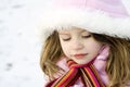 Thoughtful young girl with parka in the snow