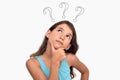Thoughtful young girl with three question marks