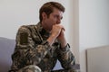 Thoughtful young handsome soldier in military uniform.