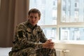 Thoughtful young handsome soldier in military uniform.