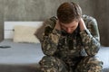 Thoughtful young handsome soldier in military uniform.