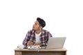 Thoughtful young man looking away while sitting at his working Royalty Free Stock Photo