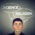 Thoughtful young man making up his mind science or religion Royalty Free Stock Photo