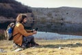 Thoughtful young man studying map on modern digital tablet on nature Royalty Free Stock Photo