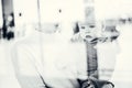 Thoughtful young mother looking trough window holding his infant baby boy child while waiting to board an airplane at Royalty Free Stock Photo