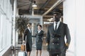 thoughtful young pilot in airport with stewardesses Royalty Free Stock Photo