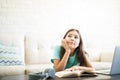 Bored girl daydreaming while studying and looking away Royalty Free Stock Photo