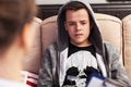 Teenager boy sitting at counseling - in front of the therapy professional, close up Royalty Free Stock Photo