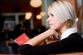 Thoughtful young woman in a cafeteria Royalty Free Stock Photo