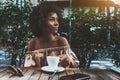 Thoughtful young woman with cup of coffee outdoors Royalty Free Stock Photo