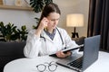 Thoughtful young woman doctor look at office computer screen ponder on establishing correct diagnosis choose treatment. Hard Royalty Free Stock Photo