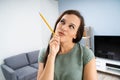 Thoughtful Young Woman In Living Room