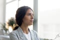 Thoughtful young woman look in distance visualizing