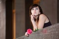 Thoughtful young woman with rose. Royalty Free Stock Photo