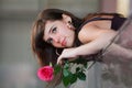 Thoughtful young woman with rose. Royalty Free Stock Photo