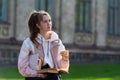 Thoughtful young woman snacking on a bun