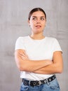 Thoughtful young woman standing in contemplative position