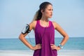 Thoughtful young woman standing with hands on hip at beach Royalty Free Stock Photo