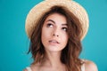 Thoughtful young woman in straw hat wondering and looking away Royalty Free Stock Photo