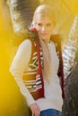 Thoughtful young woman in warm clothing standing in park