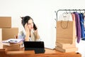 Thoughtfull Asian Female Online Shop Bussiness Owner Busy on Phone Royalty Free Stock Photo