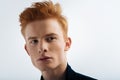 Meditative red-headed young man thinking