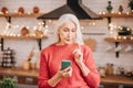 Beautiful elderly woman in red blouse looking thoughtful Royalty Free Stock Photo