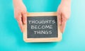 Thoughts become things is standing on a chalkboard, positive thinking and motivation concept, belief in a vision