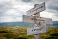 thoughts become things text engraved on old wooden signpost outdoors in nature